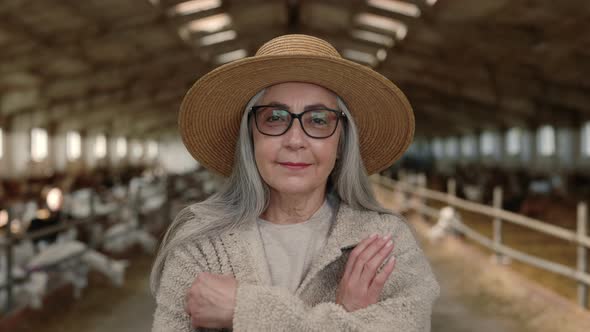 Happy Aged Female Farmer Posing at Goat Ranch
