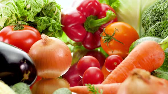 Dolly Video of Big Assortment of Fresh Seasonal Vegetables Against White Background. Concept of