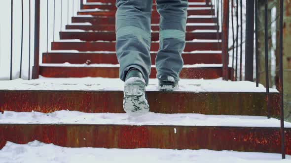 A Worker in Gray Pants with a Light Horizontal Stripe