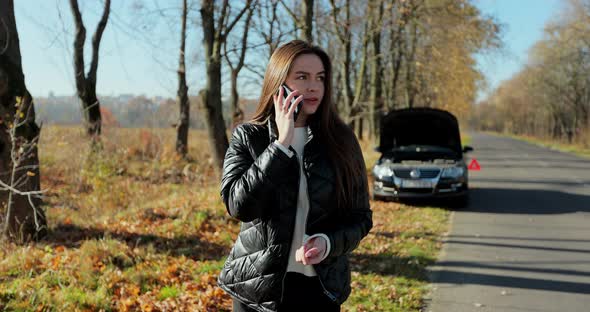Young Stressed Woman Calling for Assistance with Her Car Broken Down By the Roadside