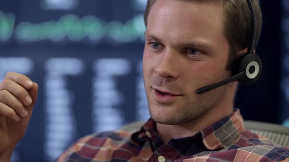 Front view of man listening and talking on headset.