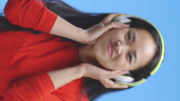 Young Woman Listening To Music on Headphones