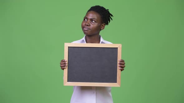 Young Beautiful African Businesswoman Holding Blackboard