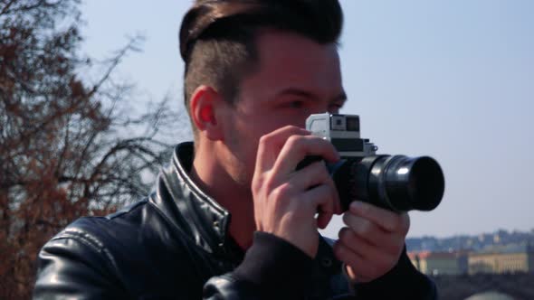 A Young Handsome Man Takes Photos with a Camera - Face Closeup - Townscape