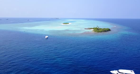 Daytime drone clean view of a white sand paradise beach and blue sea background in hi res 4K