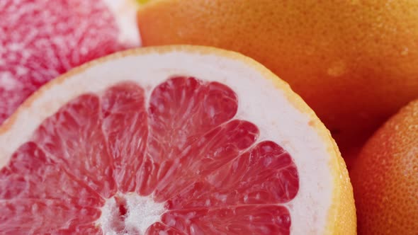 Grapefruits Isolated on Yellow Background Pouring Water on Fresh and Ripe Citrus Fruits