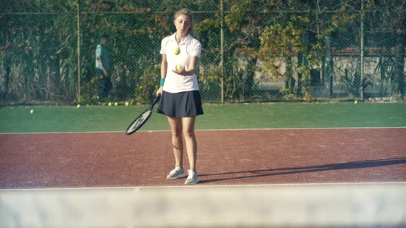 Female Tennis Player Preparing To Set Ready To Serve Ball. Girl With Rocket Playing On Tennis Court.