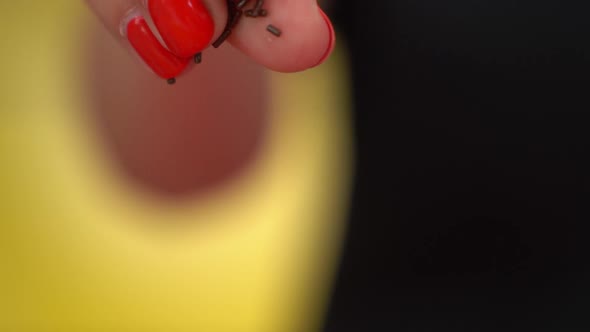 Close-up of sprinkling chocolate sprinkles in slow motion.