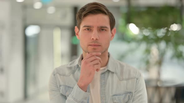 Portrait of Pensive Creative Young Man Thinking