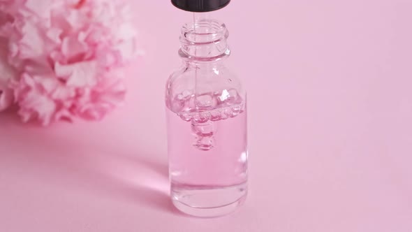 Bottle with a pipette gaining serum oil or perfume essence.