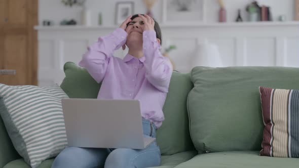 Indian Woman Getting Frustrated while Working on Laptop on Sofa