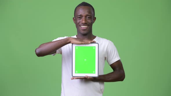 Young Happy African Man Showing Digital Tablet