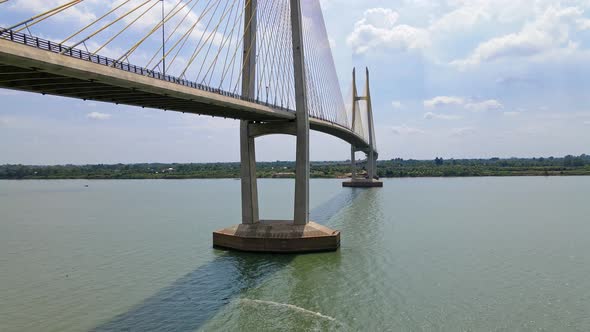 Ascending drone shot of huge Tsubasa Bridge with traffic over Mekong River near Phom Penh. Longest B