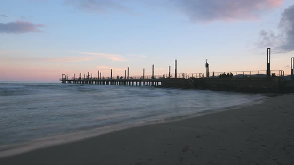 Alassio pier timelapse with people tourist holiday. Mediterranean sea shore coastline in Liguria, tr