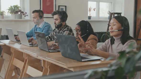 Call Center Workers Talking to Customers