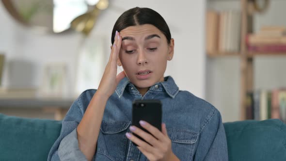 Latin Woman Loss on Smartphone