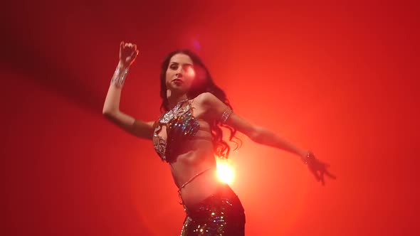 Traditional Oriental Belly Dancer Woman Dancing . Red Smoke Background. Slow Motion. Close Up