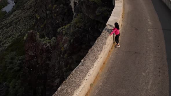 Aerial of a woman hiking across the Salmon Falls Dam in Southern Idaho