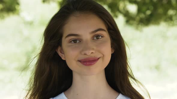 Portrait of Beautiful Brunette Student Woman Outdoor in the Summer, Looking and Smiling Close-up