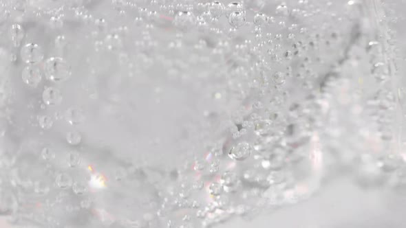 Closeup Pouring Soda Into the Glass with Ice