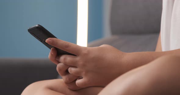 close-up of women's hands typing on the mobile