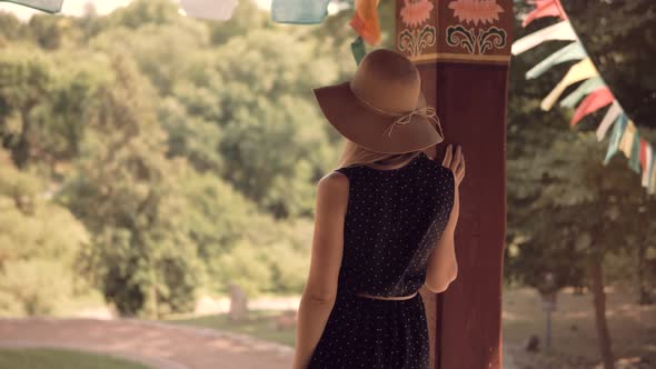 Girl Relaxing On City Park. Woman In Hat Standing And Enjoying Views.Girl In Hat On Holiday Vacation