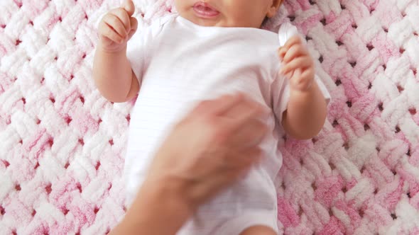 Sweet Baby Girl Lying on Knitted Plush Blanket