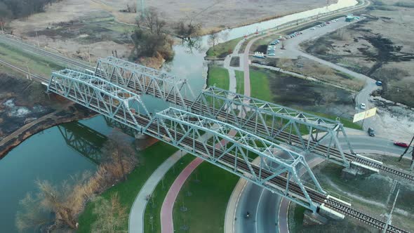 Modern railway bridge across river from bird's eye view. 