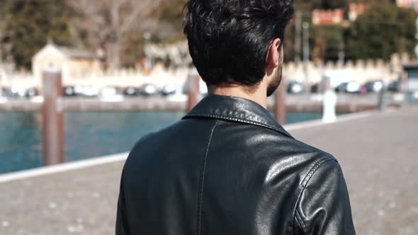 Slow motion shot of smiling man walking at harbour