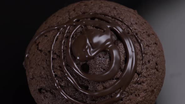 Chocolate cake brownie rotating in front of camera on black background