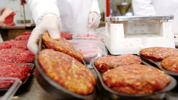 Butcher checking the weight of meat