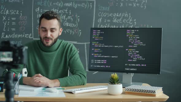 Creative Vlogger Recording Video for Social Media Teaching IT Pointing at Screen Explaining Software
