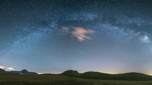 PAN: night sky over Campo Imperatore highlands, Abruzzo, Italy. The Milky Way galaxy arc and stars o