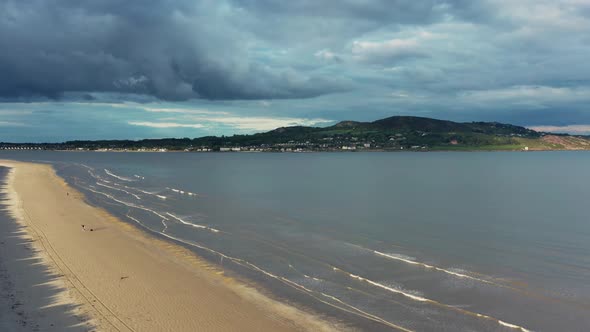 Drone rising over Irish beach