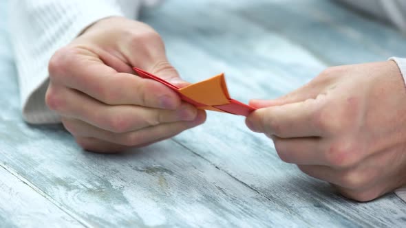 Hands Making Four Pointed Shuriken Origami.