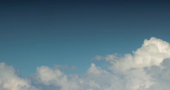 Aerial View of White Clouds Flying Across the Blue Sky