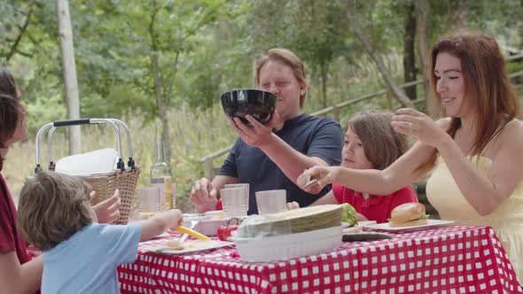 Happy Caucasian Family Going to Eat in Nature