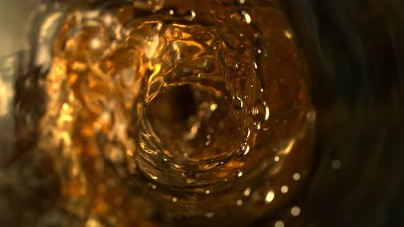 Super Slow Motion Abstract Shot of Pouring Golden Liquid in Glass Bottle at 1000 Fps