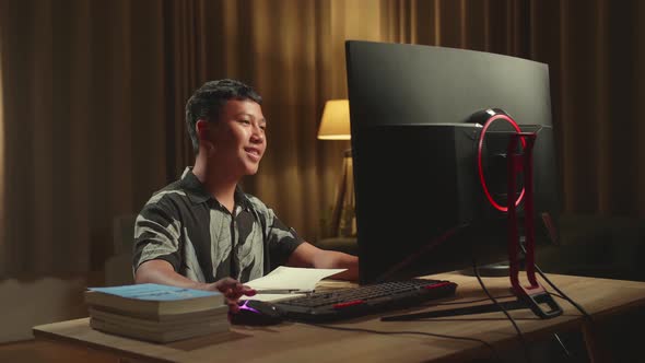 Asian Boy Learning Online, Raising Hand Distance Learning Online While Using Desktop Computer