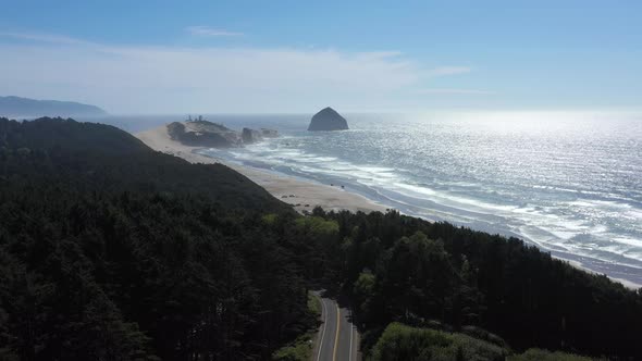 Aerial flying above highway 101 toward Cape Kiwanda State Natural Area in Oregon.
