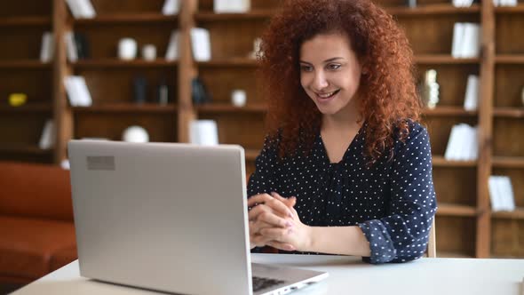 Curly Woman in Eyeglasses Stretching Arms After Using Laptop