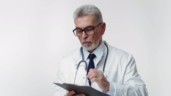 An Adult Doctor in the Studio Holds a Tablet for Paper and Pen