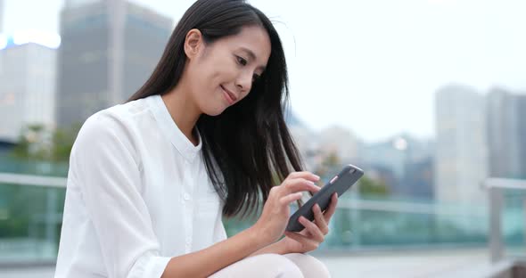 Business woman use of mobile phone in city at night