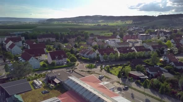 A limousine is driving through a roundabout and drives further away into the sunset in Switzerland.