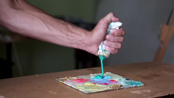 Artist Getting Ready To Paint By Mixing and Blending Paint