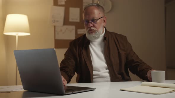 man works at a stock market through a laptop