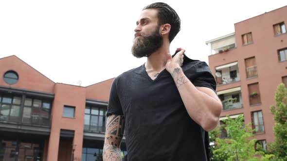 portrait young beautiful bearded man posing outdoor looking away