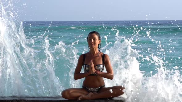 Staying Calm and Relaxed Woman Yoga and Meditation Wellbeing Training on the Ocean Coast Big Waves