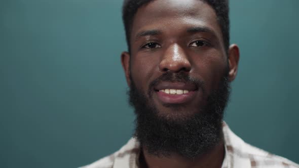 An African Young Man is Standing and Looking at the Camera