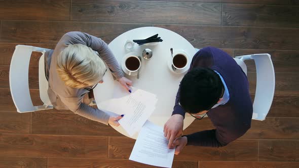 Two Business People During Work Meeting in Modern Cafe